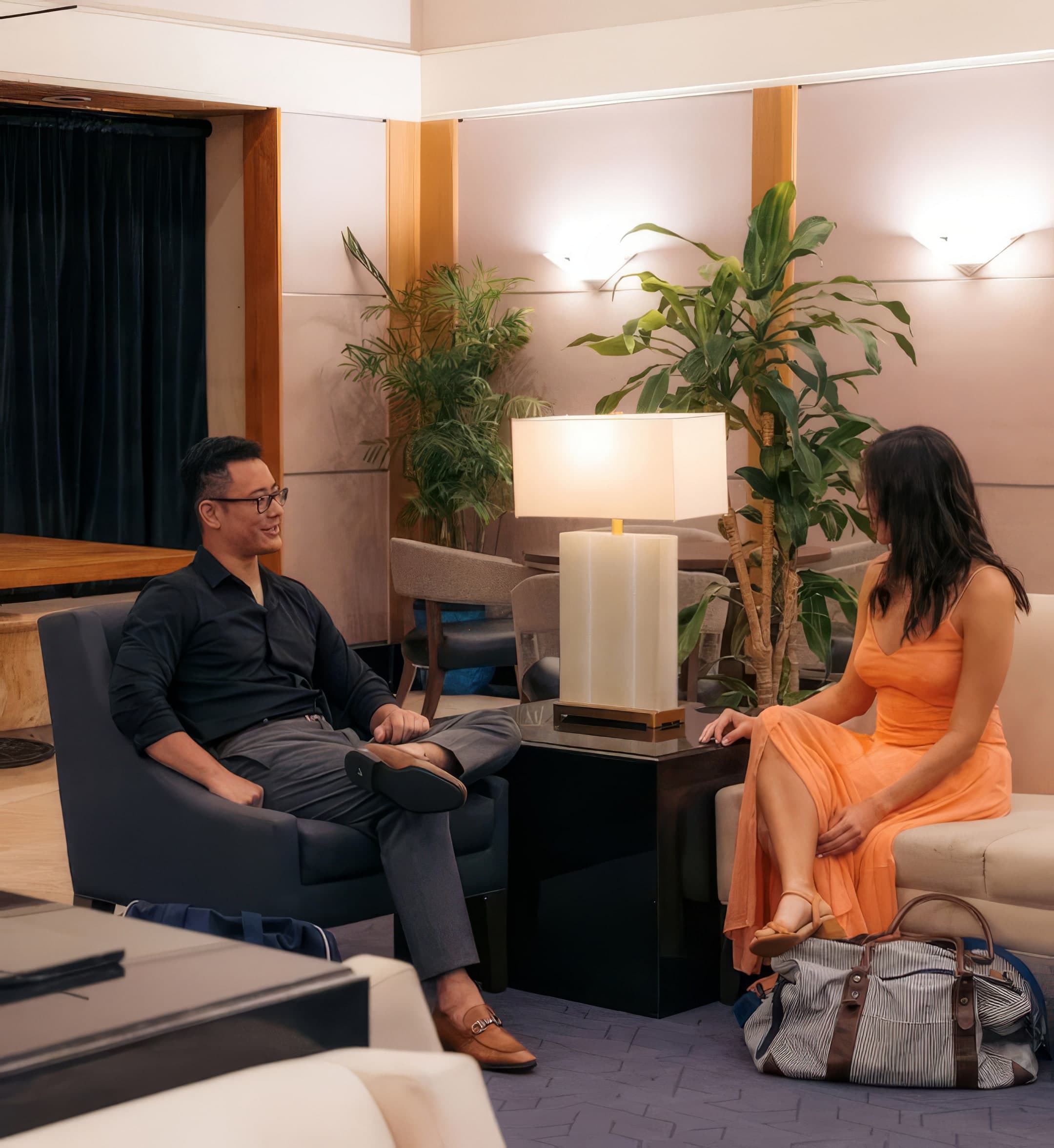Two business travellers talking in a hotel lounge