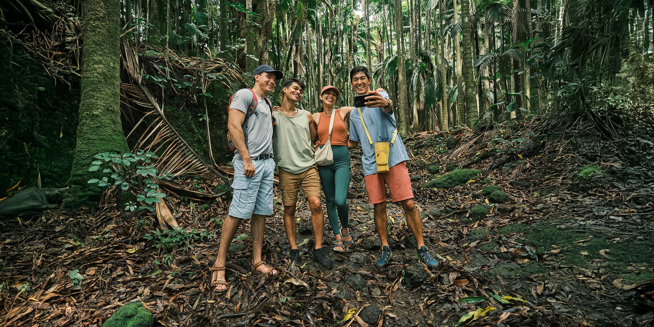 Friends taking a group selfie in a tropical jungle