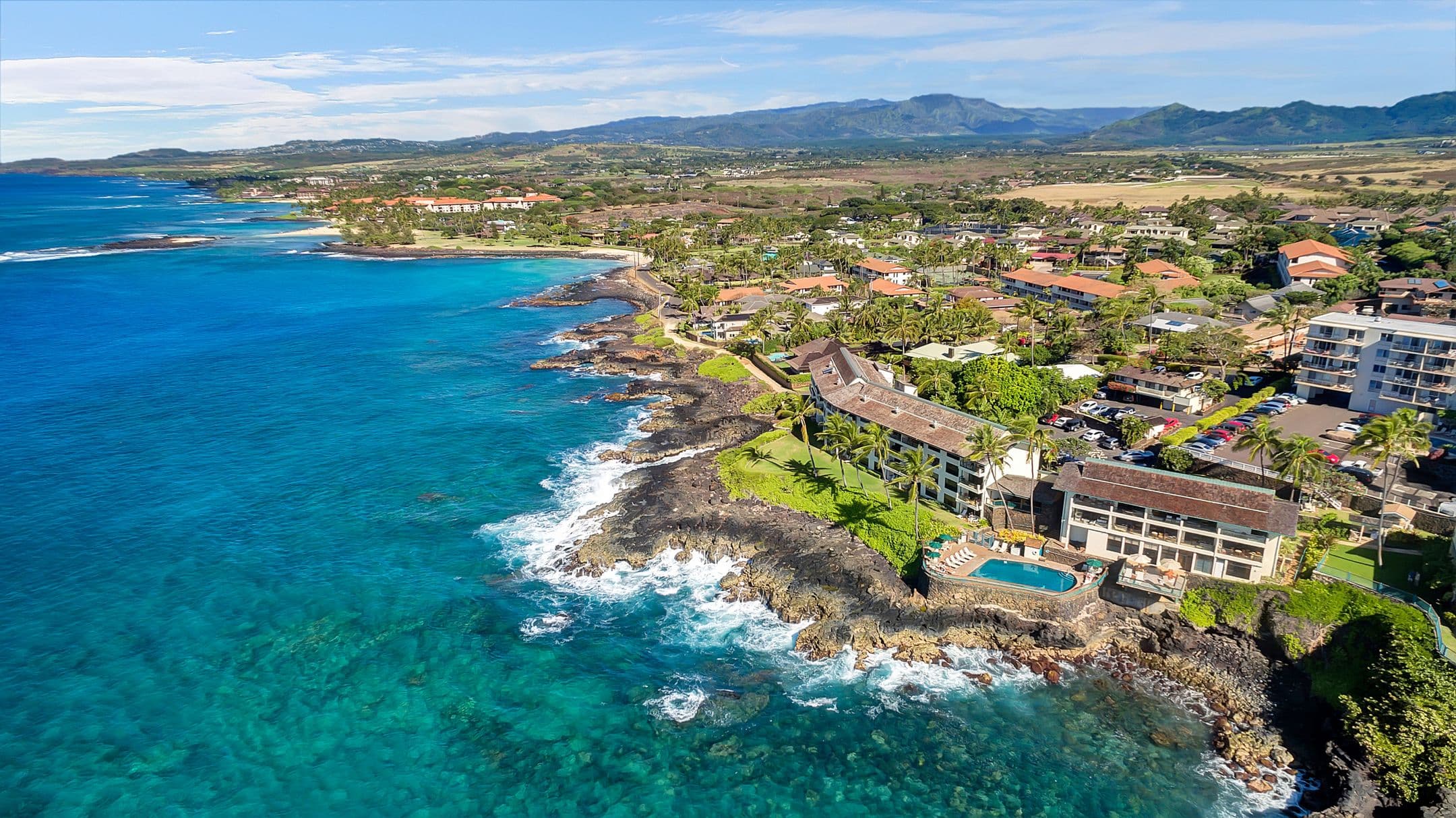 Oceanfront Castle Poʻipū Shores overlooking the Pacific from a coastal cliff on Kauaʻi's south shore