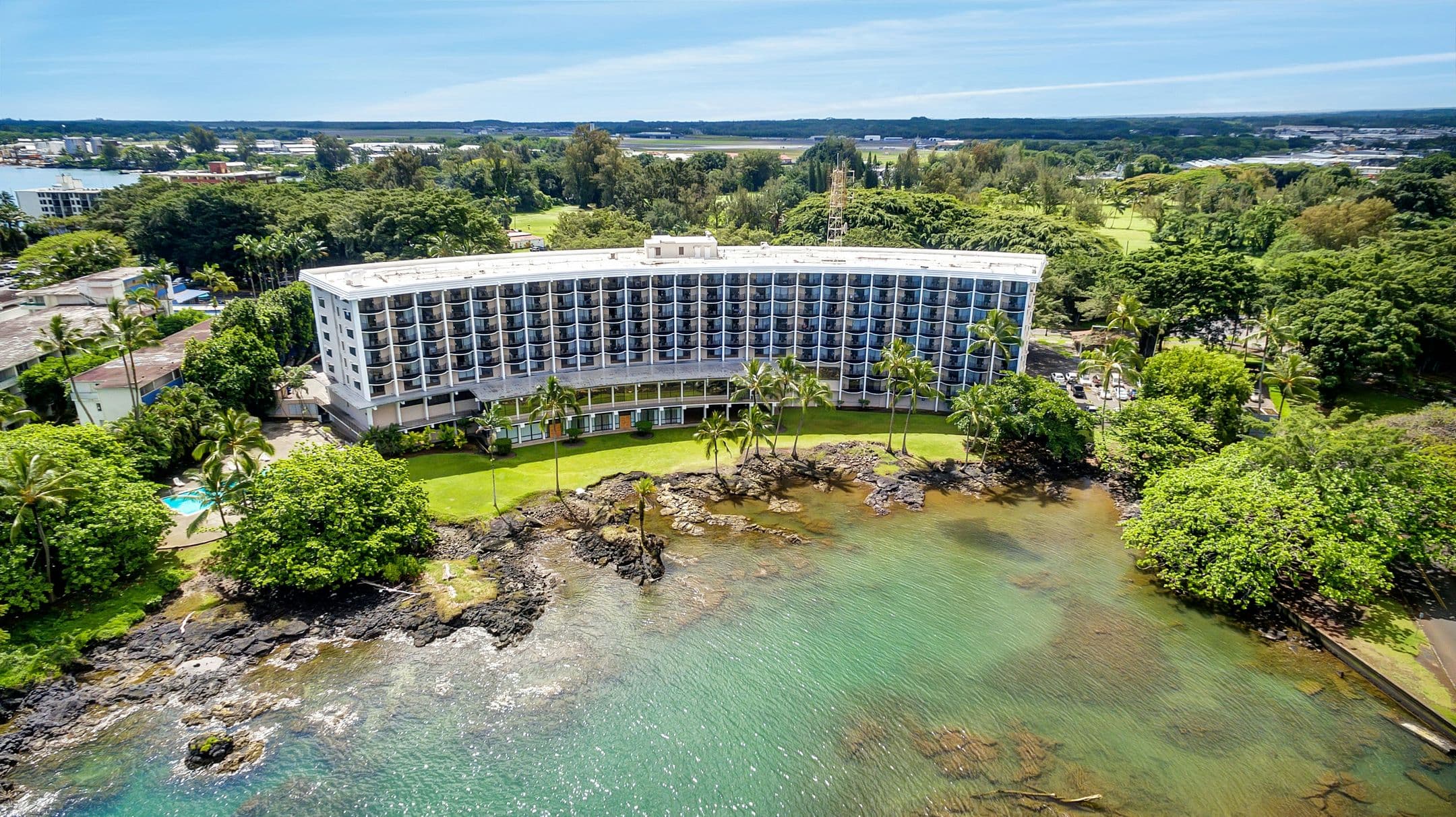 Aerial view of Hilo Hawaiian Hotel on Hilo Bay with Mauna Kea in the distance