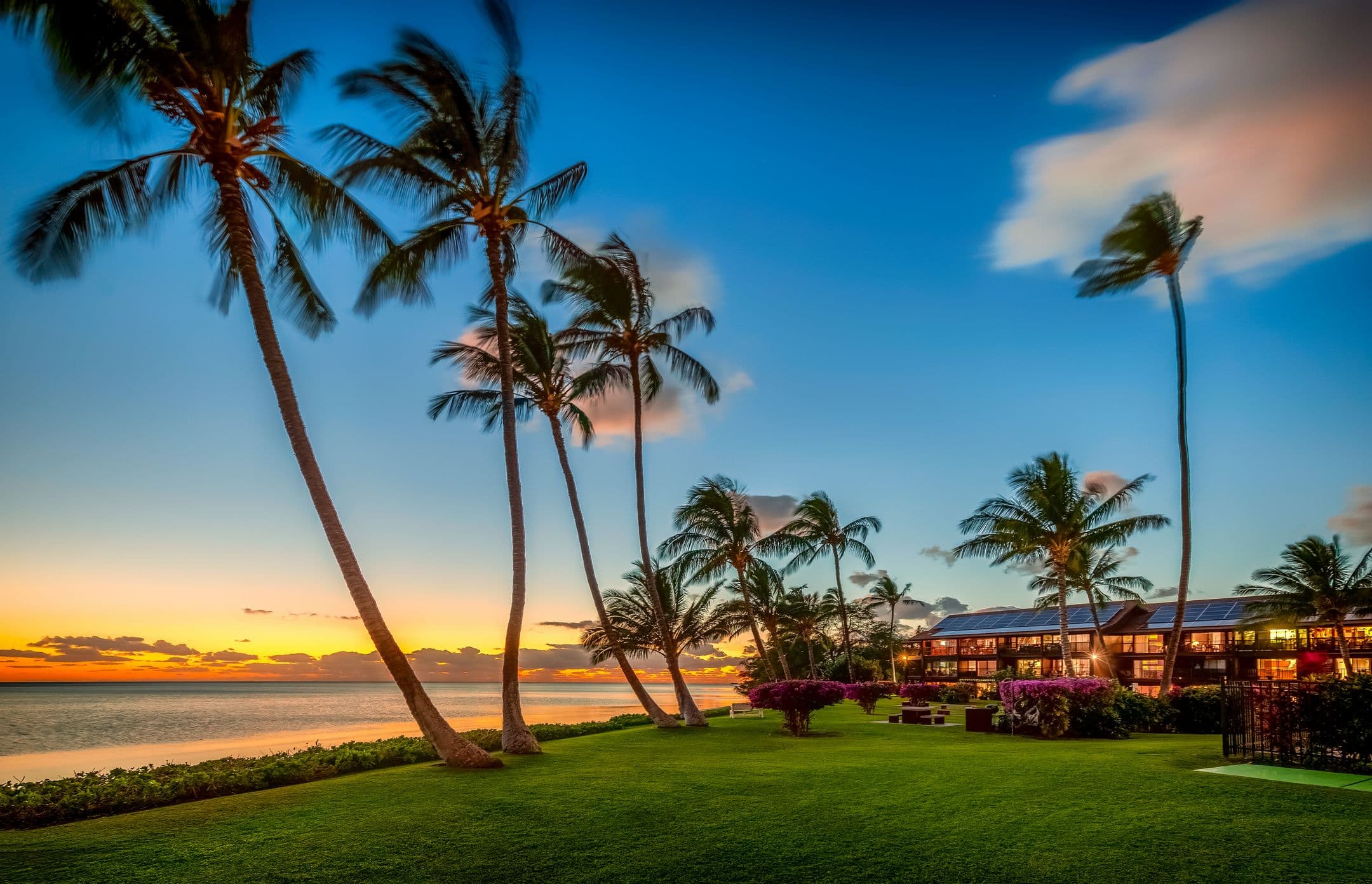 Oceanfront Castle Molokaʻi Shores on Molokaʻi's south shore with pool and lawns at sunset