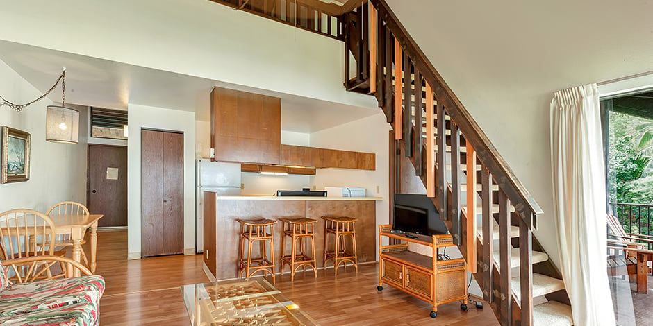 Living room area wiht stairs in a 2-Bedroom Ocean View at Molokai Shores